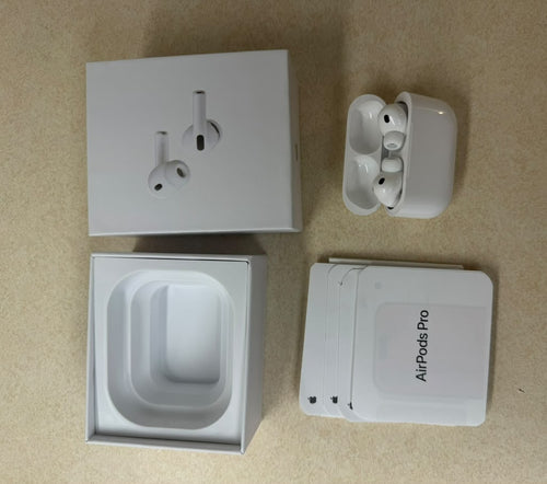 White earbuds and charging case beside packaging labeled AirPods Pro